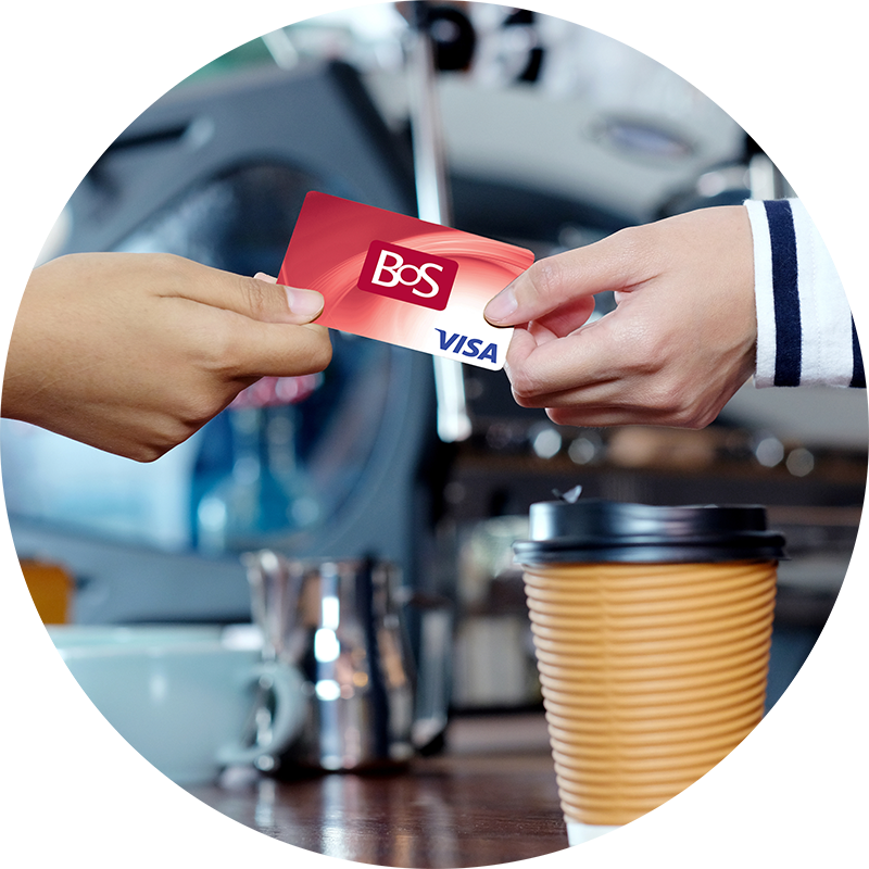 Someone handing the cashier a BOS debit card to pay for a cup of coffee.