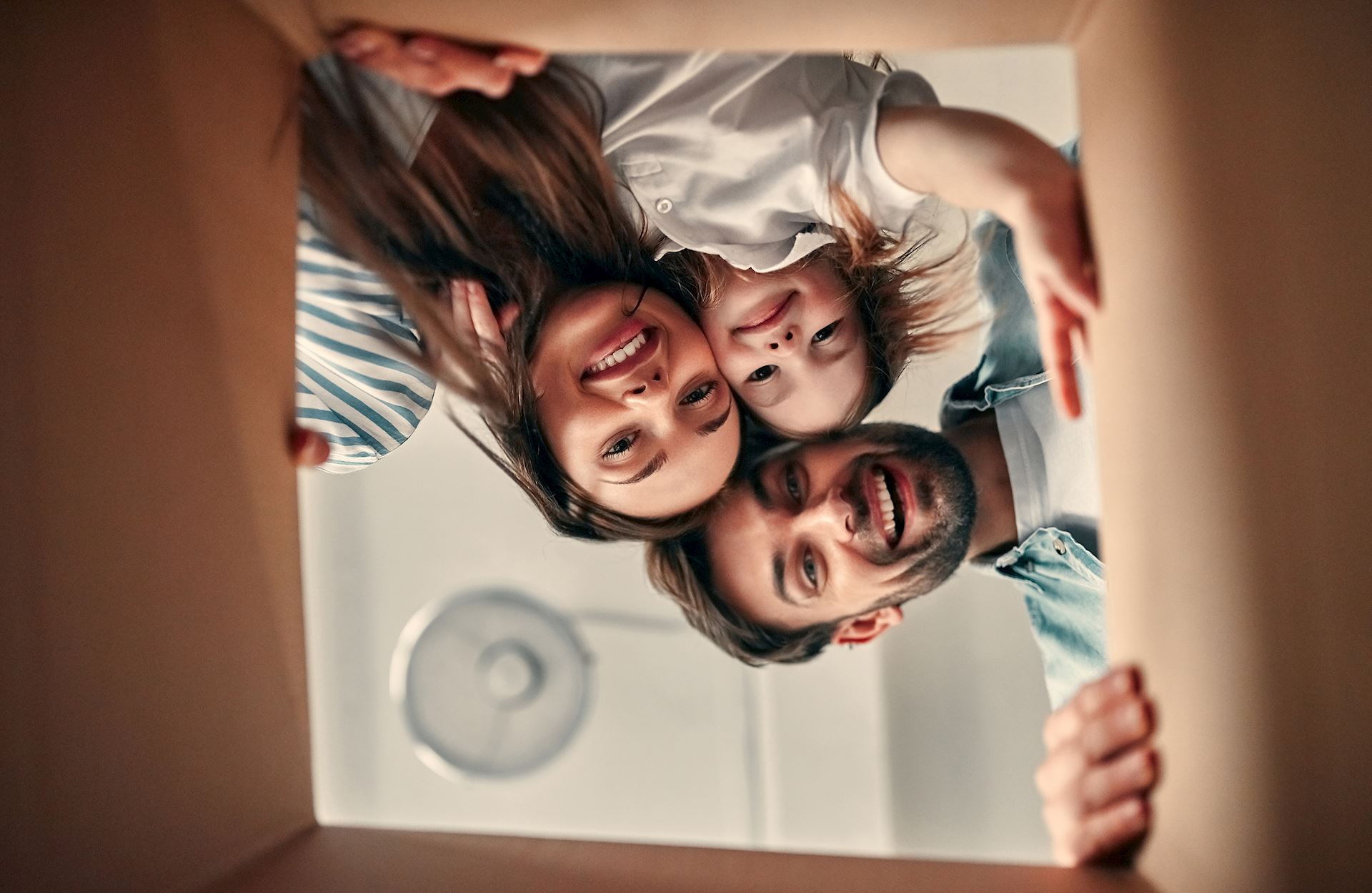 A young family looking inside a box.