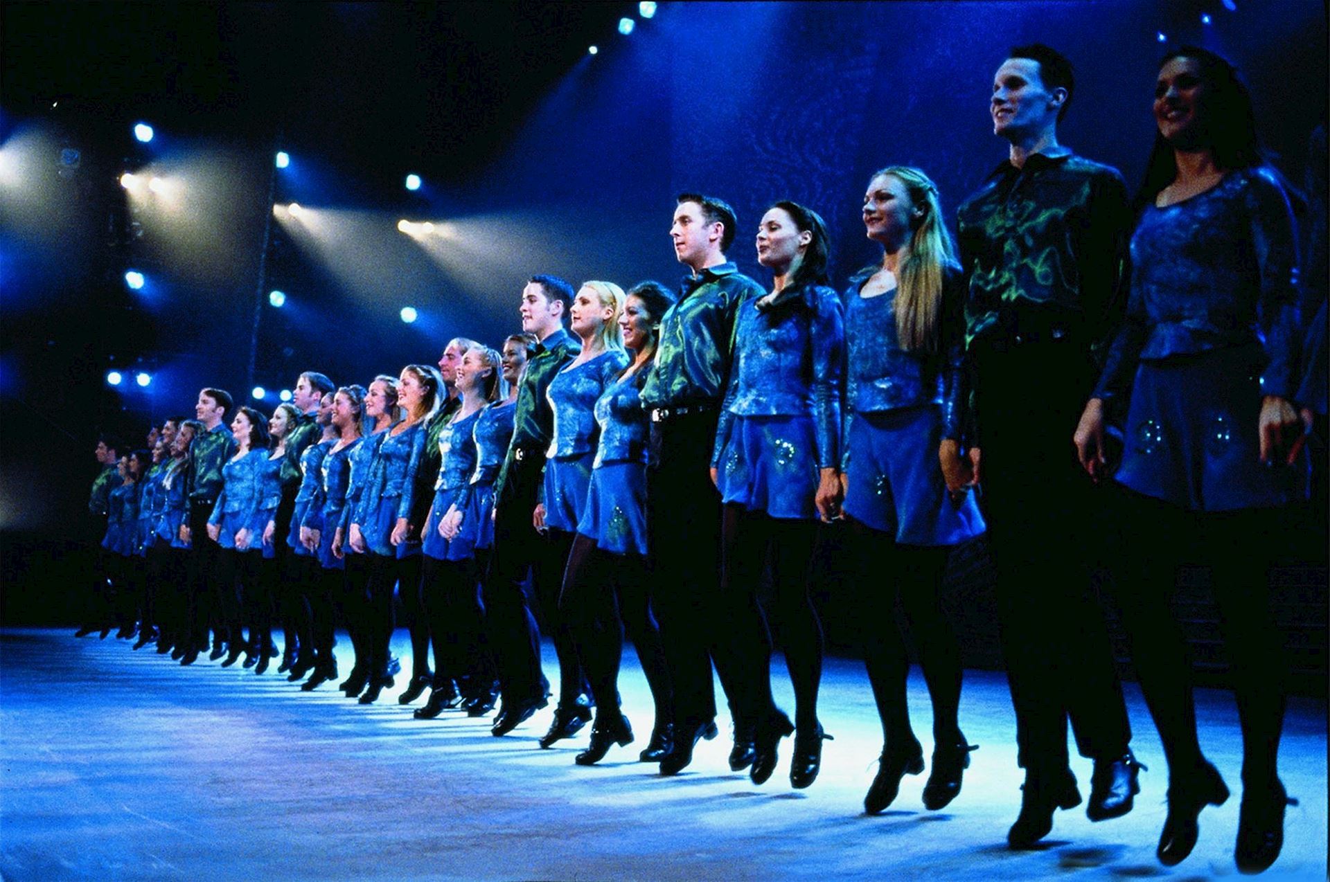 Photo of the Riverdance cast in a dance line.